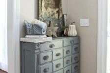 22 an apothecary cabinet painted slate looks chic and adds a vintage touch to your entryway