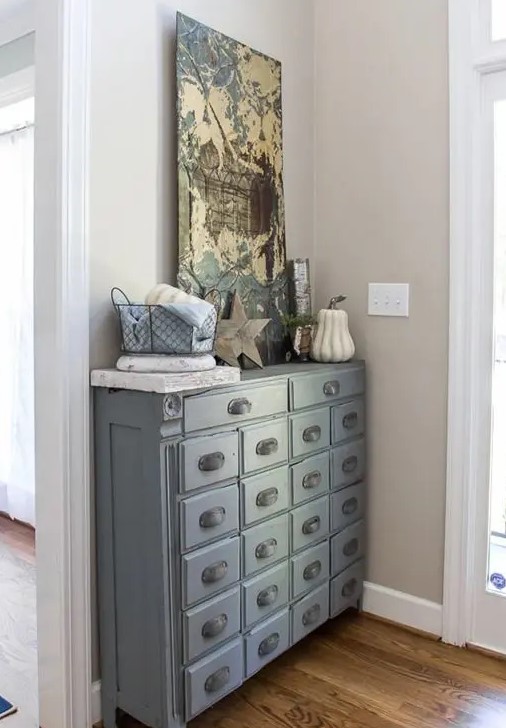 an apothecary cabinet painted slate looks chic and adds a vintage touch to your entryway