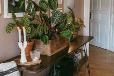 25 an elegant dark-stained hairpin leg console table with potted plants and candles is a chic and cool idea for a modern space