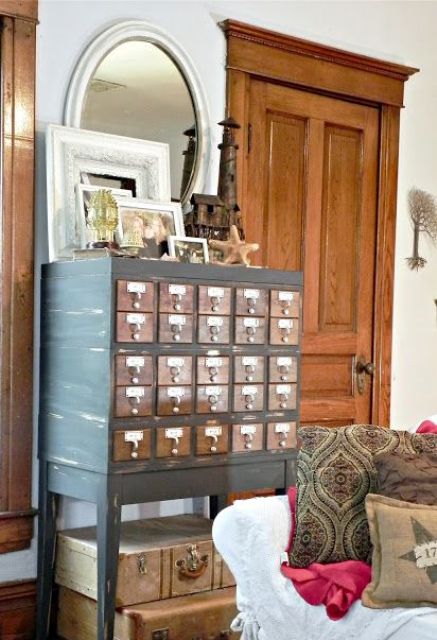 a renovated card cabinet on tall legs with various decor is a lovely soluton for a vintage or rustic entryway