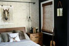 32 a chic monochromatic bedroom with a fake grey brick wall, a black statement one and animal-inspired decor