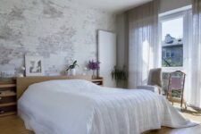 35 a contemporary bedroom with a whitewashed and shabby brick wall that adds a raw feel to the space