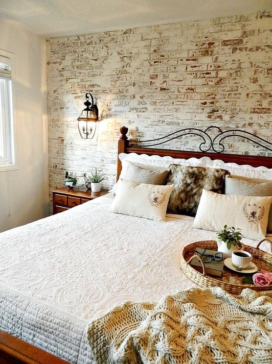a cozy rustic space with a fake whitewashed brick wall and rich stained furniture that contrasts it