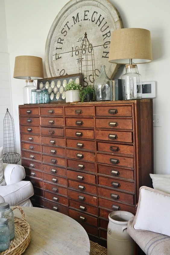 a vintage stained file cabinet with table lamps, greenery, decor is a perfect solution for shabby chic and vintage spaces