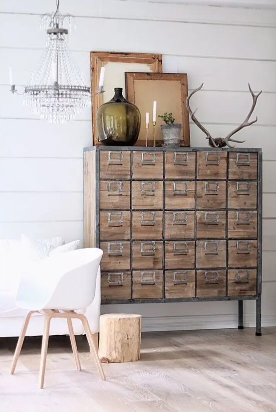 an apothecary cabinet with metal framing adds an industrial and vintage touch to the space
