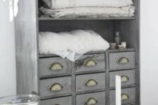 52 an apothecary cabinet painted light grey and renovated into a linen storage item for a cottage bathroom or bedroom