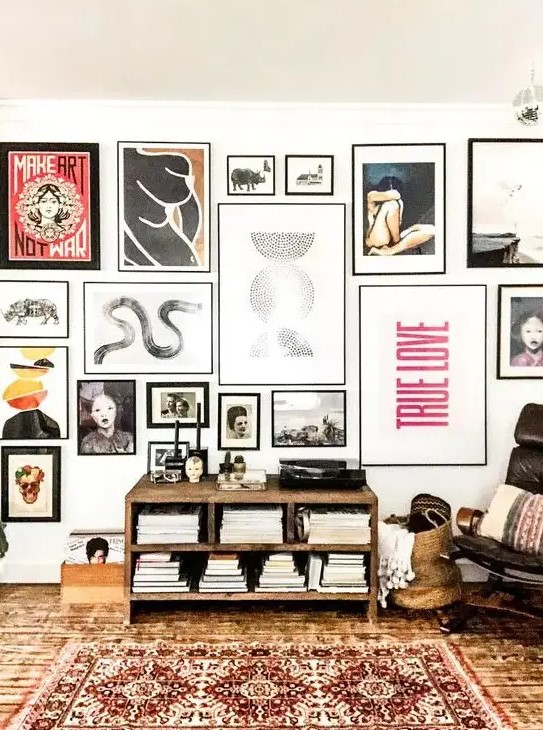 a bold and eye-catchy gallery wall with various types of art in mismatching black frames will make a statement anywhere