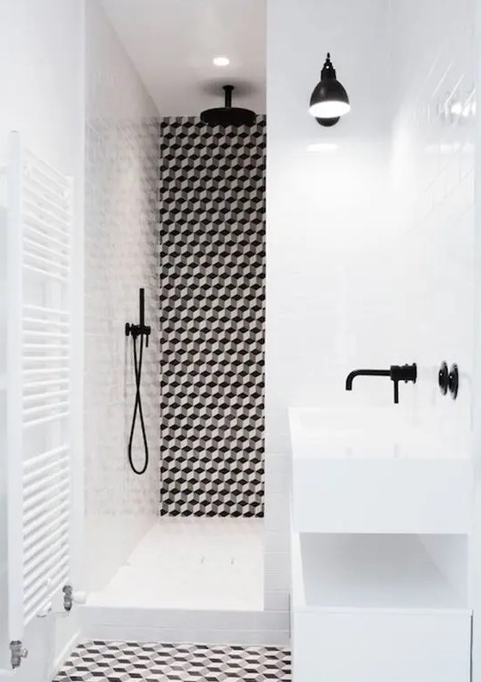 a bold black and white bathroom with geo tiles and black fixtures looks ultra-modern and very chic