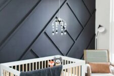 a stylish geo black accent wall in a nursery