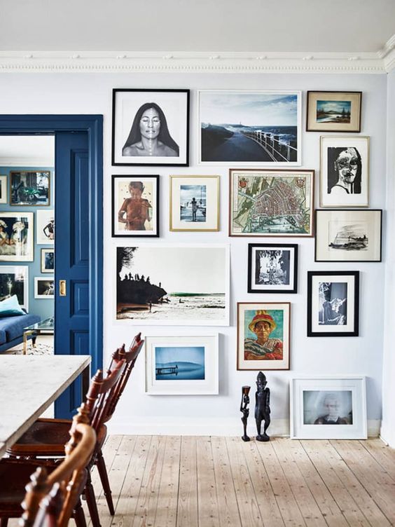 a bright floor to ceiling gallery wall that sets the tone in the space and makes it more stylish and elegant