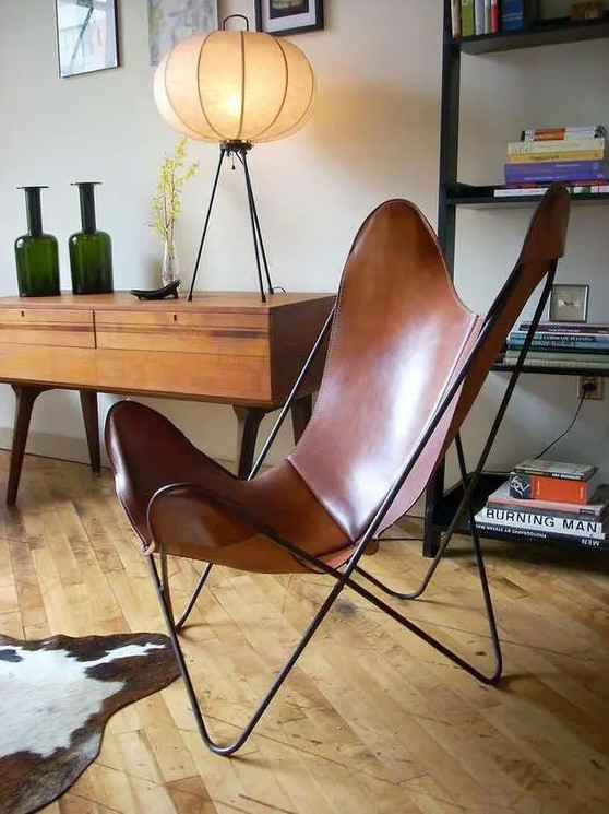 a brown leather butterfly chair is a cool mid-century modern addition to any space, it looks elegant and chic