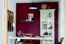a stylish craft room with a colorful wall