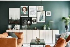 a lovely living room with a moody green accent wall