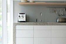 a modern kitchen with a concrete backsplash