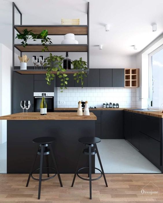 a contemporary black kitchen with butcherblock countertops, a suspended shelf over the kitchen island and a white tile backsplash
