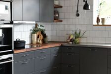 a contemporary graphite grey kitchen with white tiles and rich-colored wooden countertops to refresh