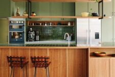 a green and stained kitchen with pofiled cabinets, suspended shelves over the kitchen island and wooden stools
