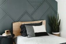 a stylish guest bedroom with a panelled wall