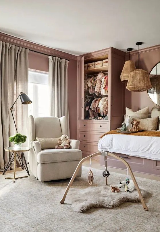 a mauve kid's room with a raised bed, a mobile and a chair, some pendant lamps is a chic place