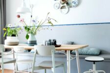 a lovely dining space with a color block pastel wall