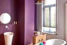 a stylish farmhouse bathroom with purple walls