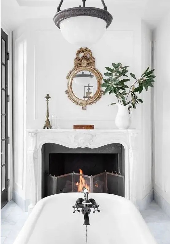a vintage French chic fireplace in the bathroom will add a chic touch to the space and will let you enjoy two elements