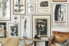 a vintage black and white gallery wall with mismatching frames and vintage art is a stylish idea