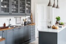 a vintage graphite grey kitchen with whitewashed wooden floors, wooden countertops and white walls to make it look fresher