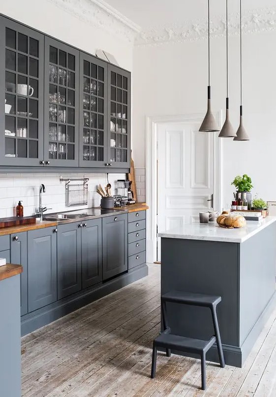 a vintage graphite grey kitchen with whitewashed wooden floors, wooden countertops and white walls to make it look fresher