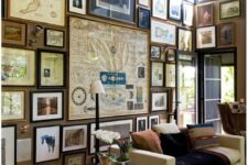 a vintage living room wiht a floor to ceiling gallery wall with a vintage drawing, a white sofa and a brown chair and a crate side table