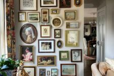a vintage space with a floor to ceiling gallery wall with various frames and mostly paintings is a very cool and chic idea