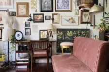 an eclectic living room gallery wall with various artwork, masks, mini sculptures and botanical posters is lovely