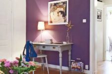 an elegant space with a purple accent wall, a vintage home office nook with grey furniture, bold blooms and white furniture
