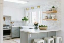 an ethereal kitchen with dove grey lower cabinets, white upper ones, white countertops and tile walls plus touches of gold
