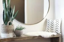 an oversized round mirror in a brass frame is a cool modern idea suitable for boho or contemporary spaces