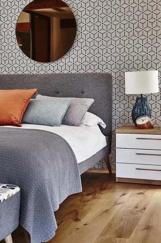 bold, geometric wallpaper and mid-century modern furniture create a cool themed look in this bedroom