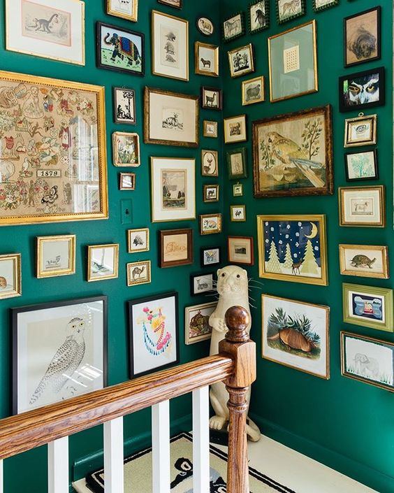 emerald walls with a floor to cieling gallery wall that takes them both - that's a cool way to accent your staircase nook