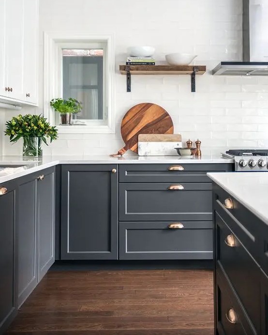 graphite grey cabinets are made more elegant with metallic handles and white tabletops
