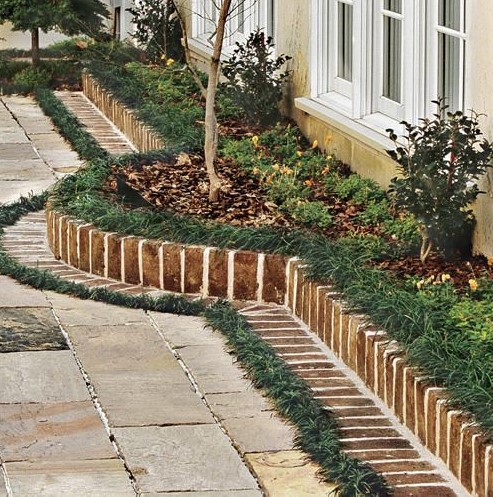 a brick border is a timeless idea to use in any garden, though it's a bit formal, it's cool