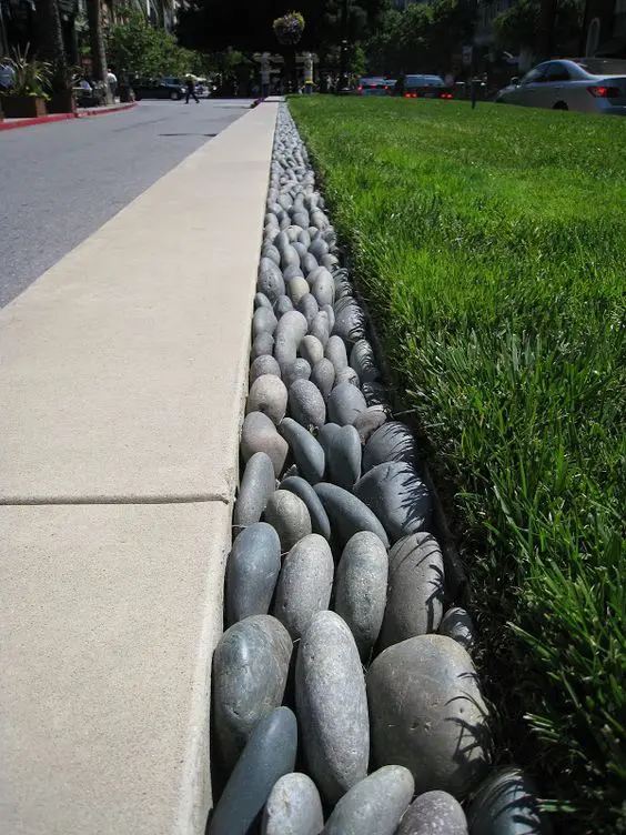 pebble garden edging is a cool and lovely decor ideea that looks nice and very minimal and brings a cool natural feel to the space