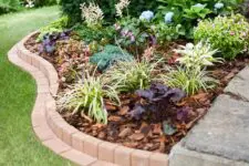 09 an elegant curved brick flowerbed border is a stylish and cool idea that looks cool and chic and will match many garden styles