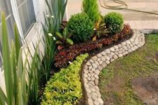 10 a stylish and creative pebble border is a cool way to add texture and interest to your raised garden bed