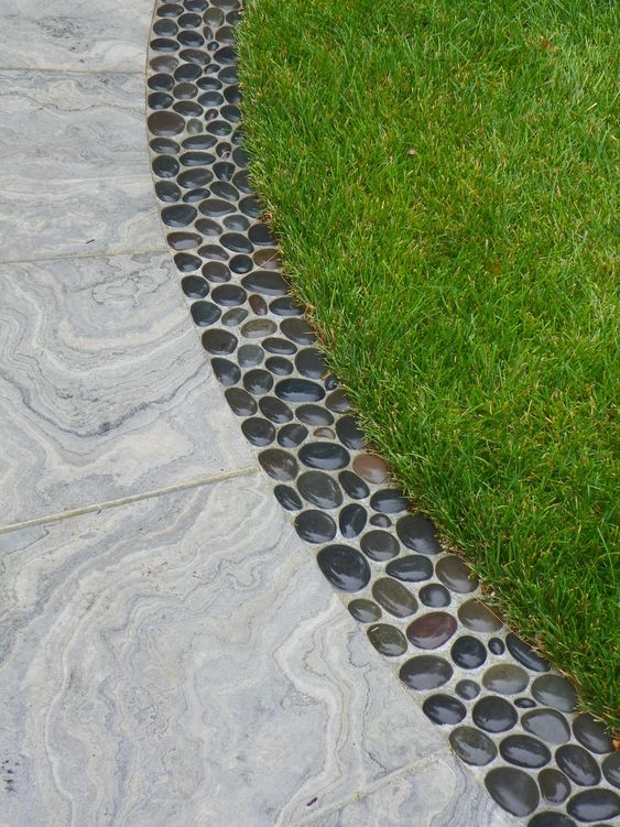 stylish concrete and pebble garden edging adds a natural feel and brings a cool touch to the space making it less formal