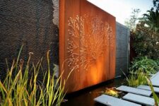 12 a modern pond with tiles over the water, with water plants and an orange metal wall with detailing are a bold and chic combo