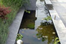 13 a modern pond with water plants, metal balls for decor and a waterfall will make your outdoor space cool and catchy