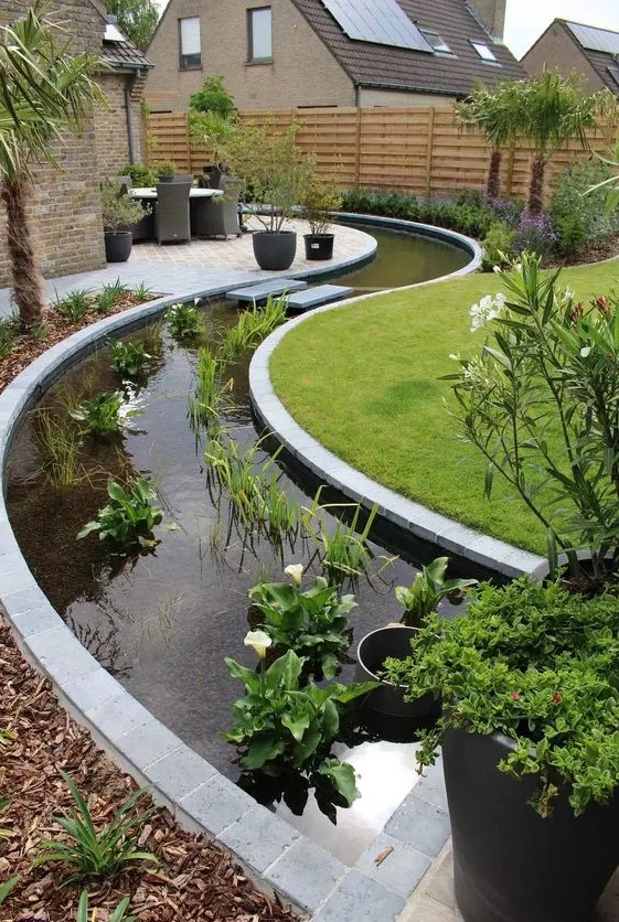 an ultra modern curved water garden of greenery and white blooms is an amazing idea for a modern garden