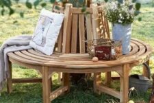 17 a classic wooden wrap around bench for a tree, with blankets, pillows and wire baskets is a lovely rustic decor idea
