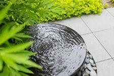21 a modern bowl fountain surrounded with pebbles and super bold grasses and grasses is a lovely idea for a modern garden