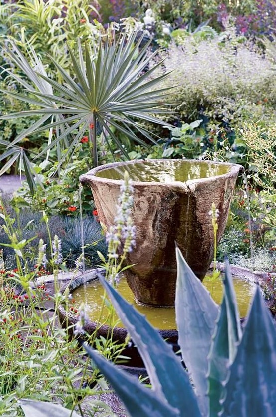 a bowl fountain of stone looks pretty natural and doesn't stand too much in your desert garden