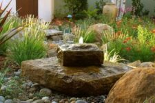 23 a gorgeous rock fountain looks very natural and cool in a desert garden
